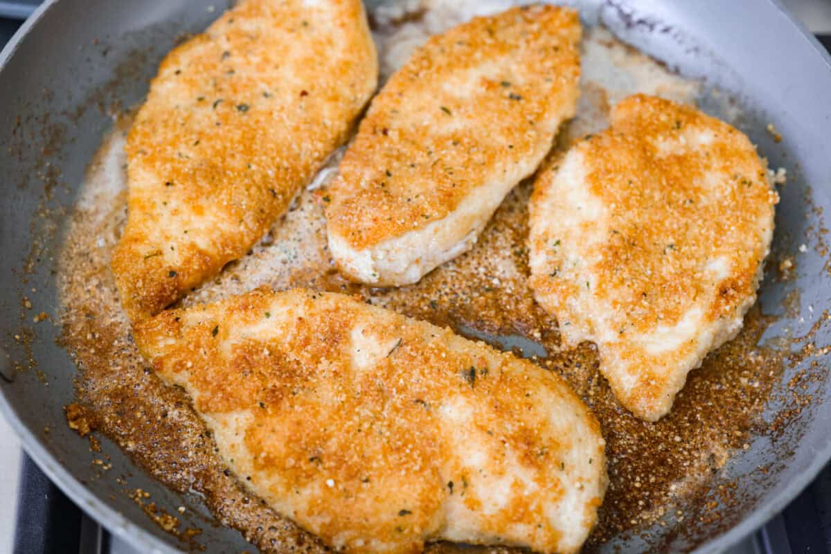 My family and I cannot get enough of this versatile summer vegetable! Whether you use it for a side dish or the entrée, its tender texture and ability to absorb flavor is unmatched. Take advantage of zucchini being in season and try out some of my other favorite zucchini recipes! Chicken cooking in a skillet.