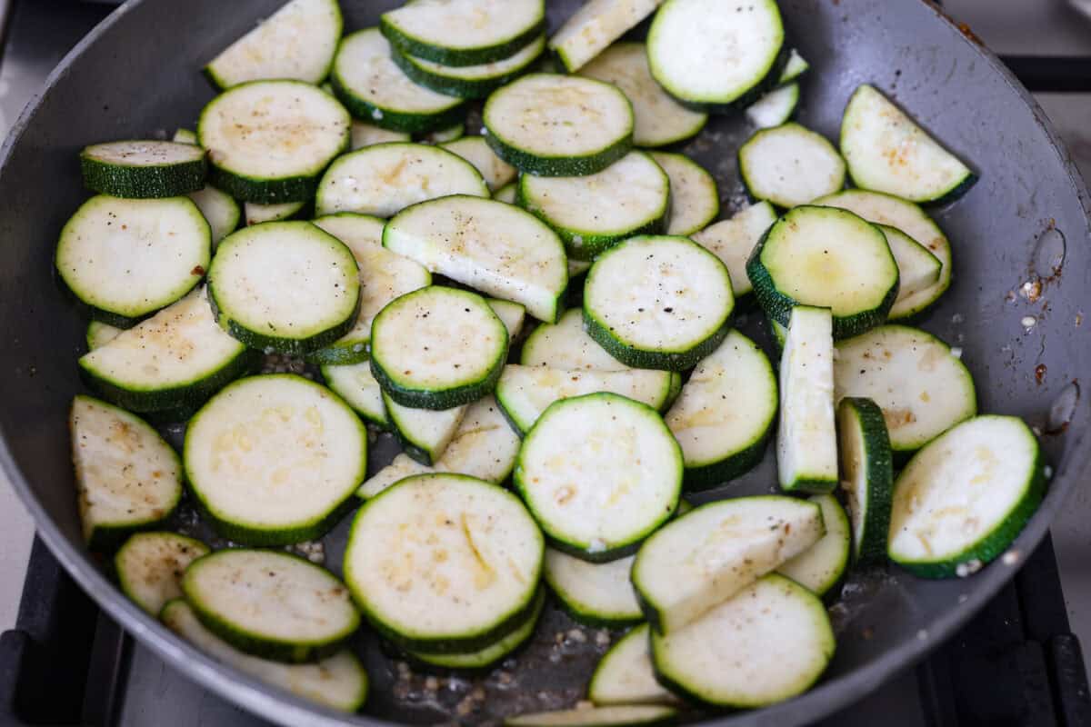 My family and I cannot get enough of this versatile summer vegetable! Whether you use it for a side dish or the entrée, its tender texture and ability to absorb flavor is unmatched. Take advantage of zucchini being in season and try out some of my other favorite zucchini recipes! Zucchini sautéing in a skillet.