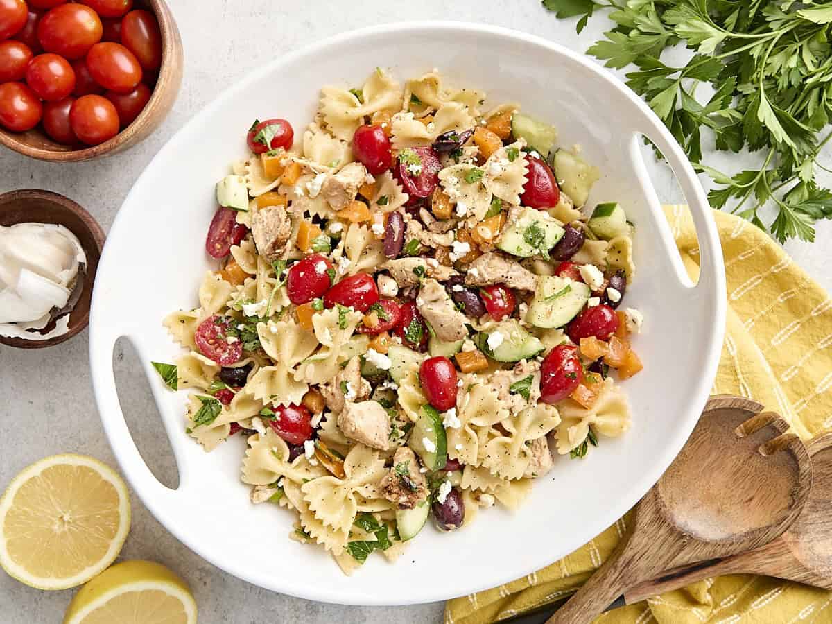 Overhead view of a homemade Greek chicken pasta salad on a platter.