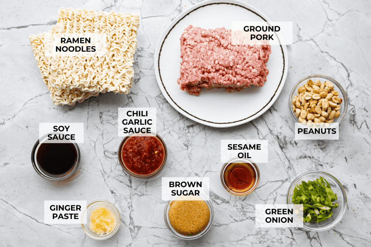These dragon noodles are the ultimate weeknight dinner when you’re craving big flavor fast. Tender noodles, spicy-sweet sauce, and savory pork come together for a dish that’s fast, fiery, and seriously addictive. Overhead shot of labeled dragon noodle ingredients.