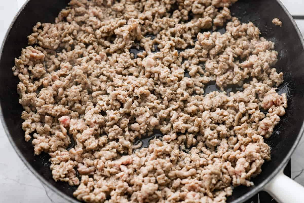 These dragon noodles are the ultimate weeknight dinner when you’re craving big flavor fast. Tender noodles, spicy-sweet sauce, and savory pork come together for a dish that’s fast, fiery, and seriously addictive. Ground pork cooking in a skillet.