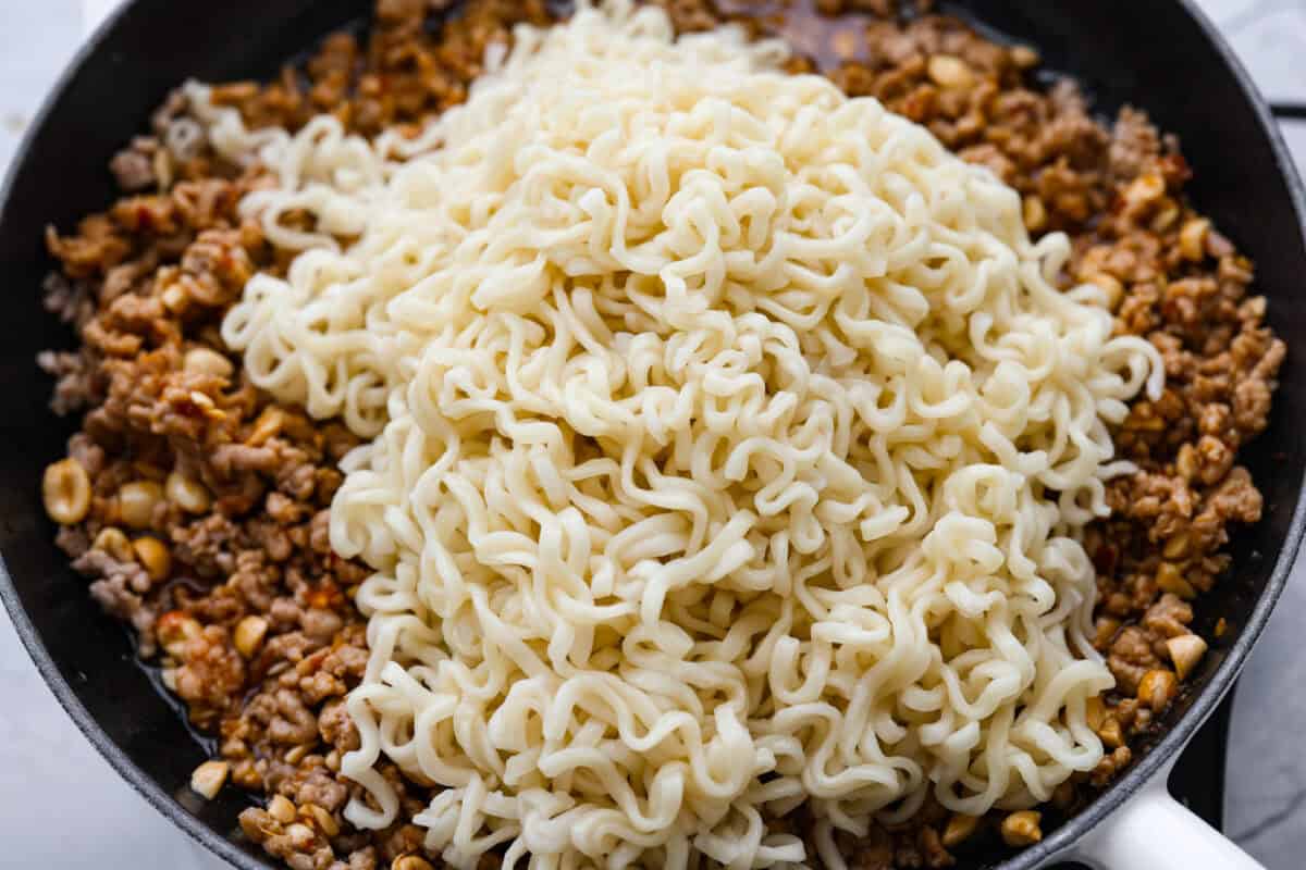 These dragon noodles are the ultimate weeknight dinner when you’re craving big flavor fast. Tender noodles, spicy-sweet sauce, and savory pork come together for a dish that’s fast, fiery, and seriously addictive. Noodles added to the meat and sauce mixture.