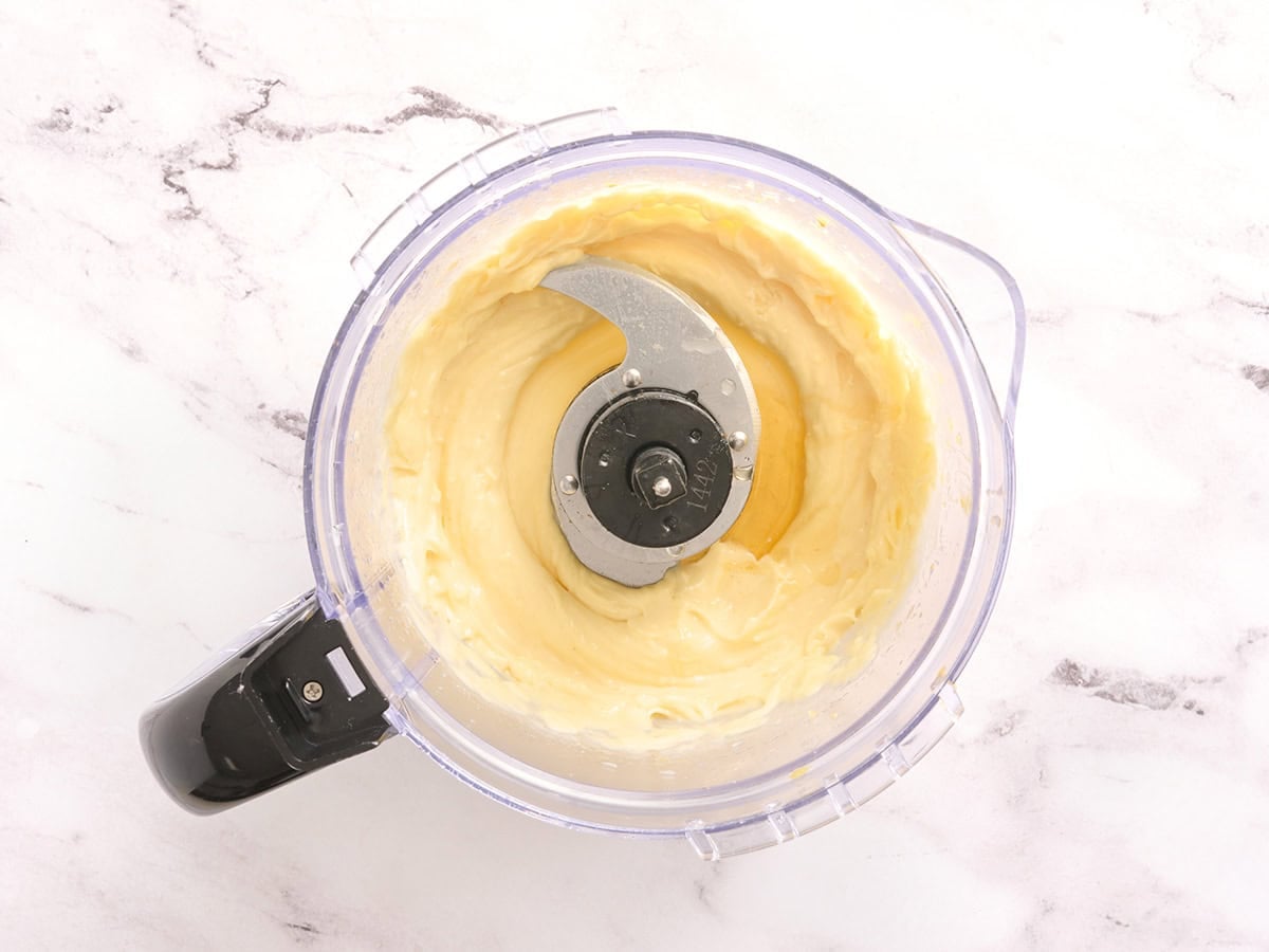 Honey and lemon juice added to a food processor with garlic aioli.