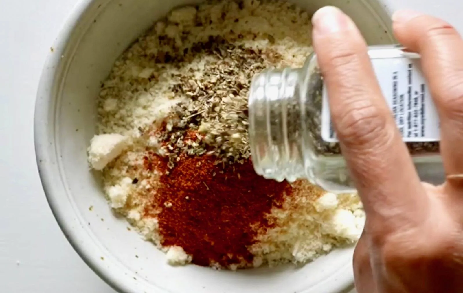 Mixing spices in a bowl.