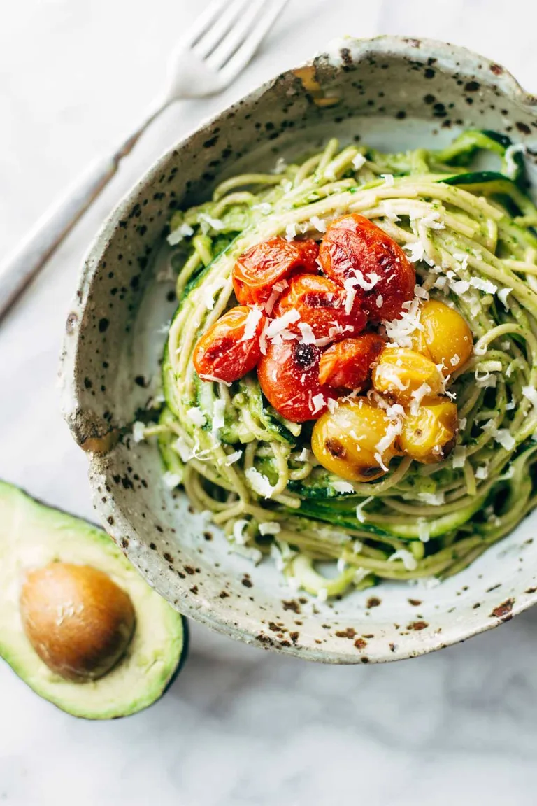 Zucchini spaghetti with burst tomato.