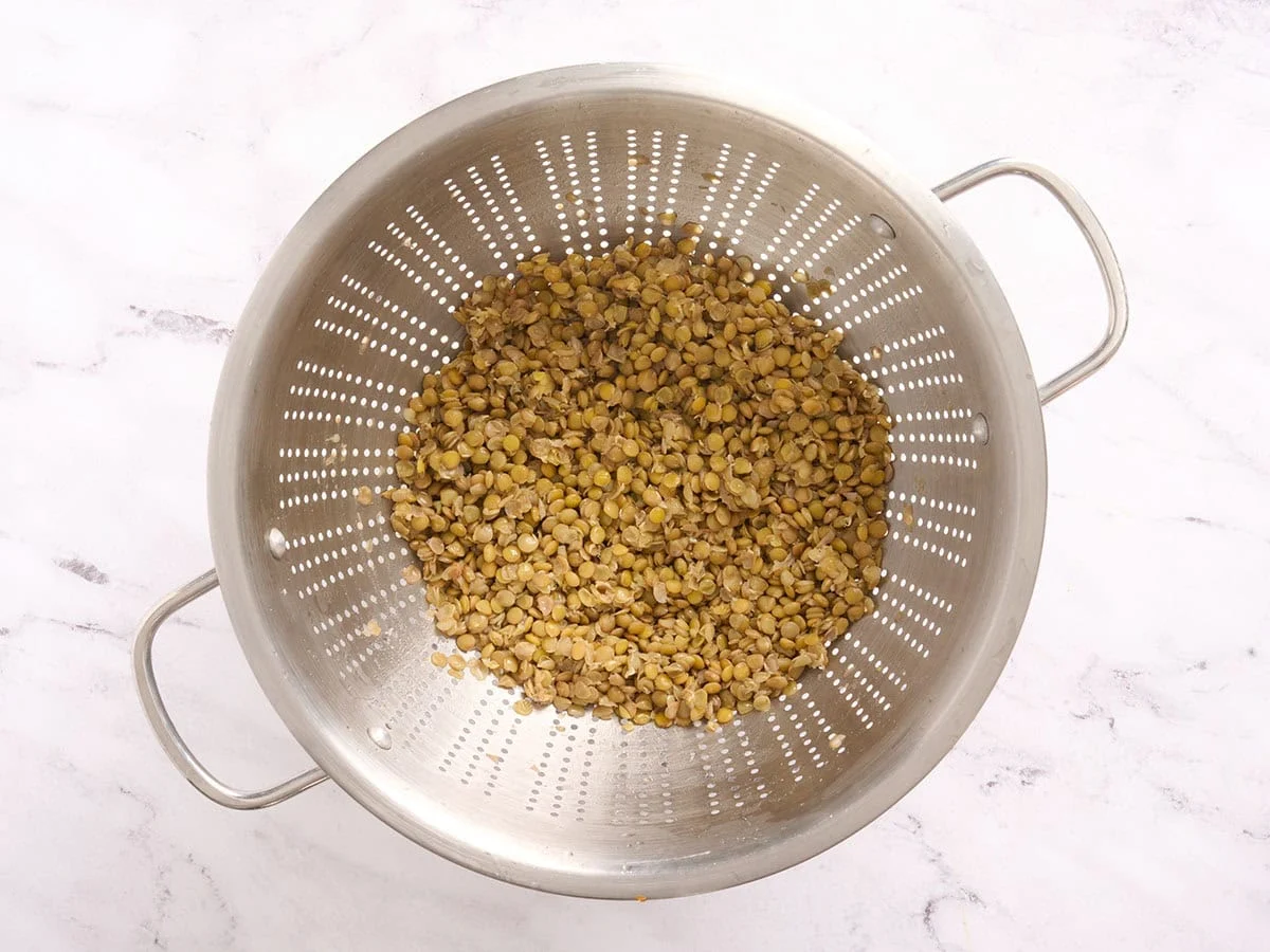 Cooked lentils in a colander.