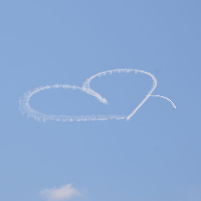 Heart drawn in the blue sky by a skywriting aircraft