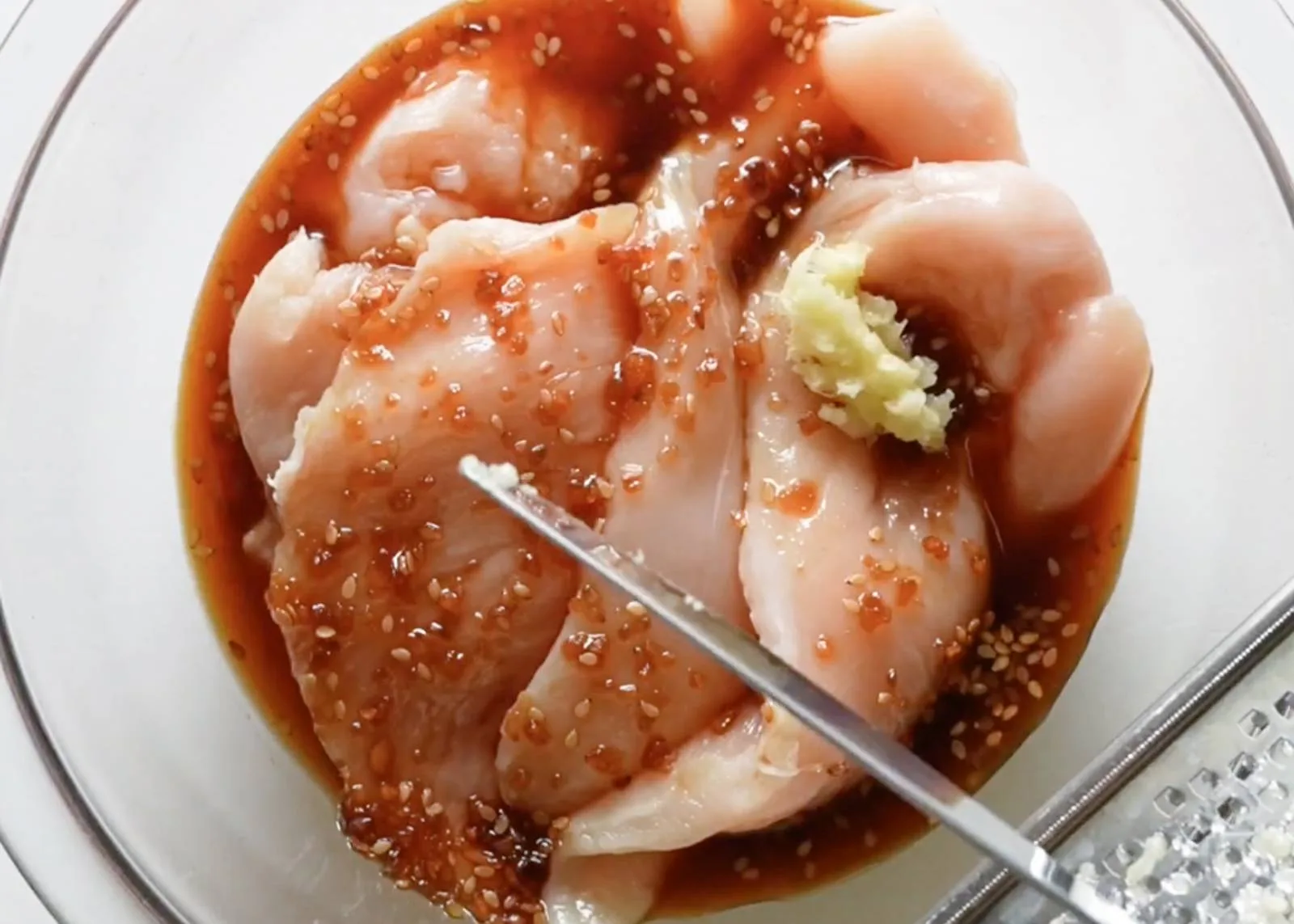 Marinating chicken in a bowl.