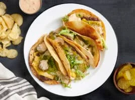 Overhead view of a plate of homemade smash burger tacos.