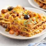 Sided view of a slice of taco casserole on a plate.