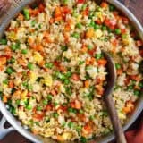 Overhead view of vegetable fried rice in a skillet.