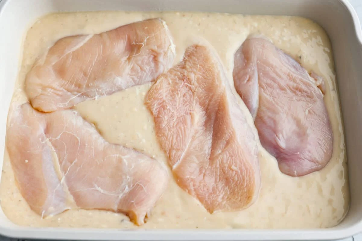chicken and rice casserole could not be easier Chicken breasts added over the top of the sauce then seasoned.