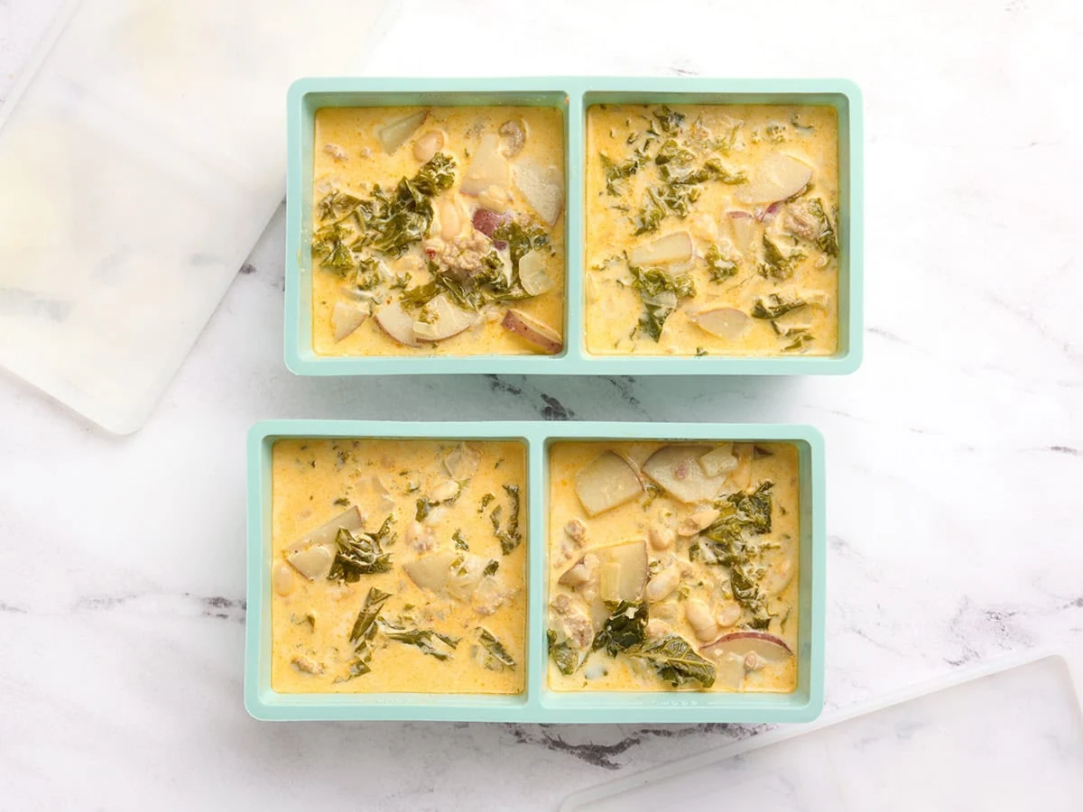 Overhead view of zuppa toscana in ice cube molds.