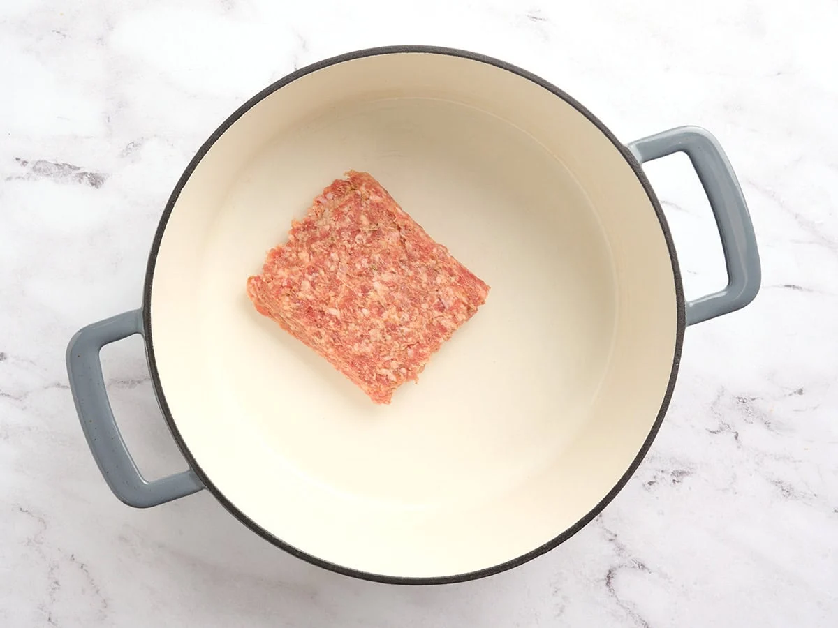 Ground sausage in a pot.
