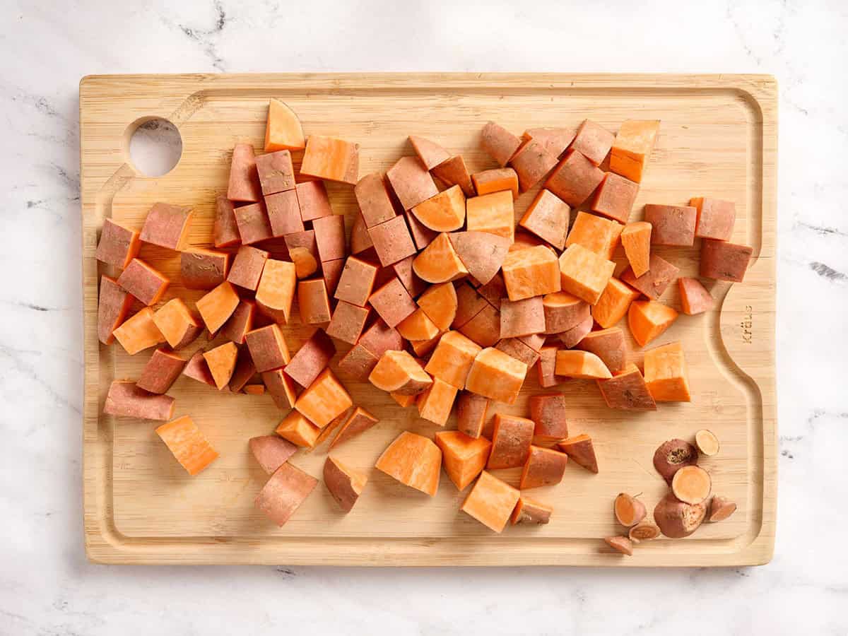 Diced sweet potatoes on a cutting board.