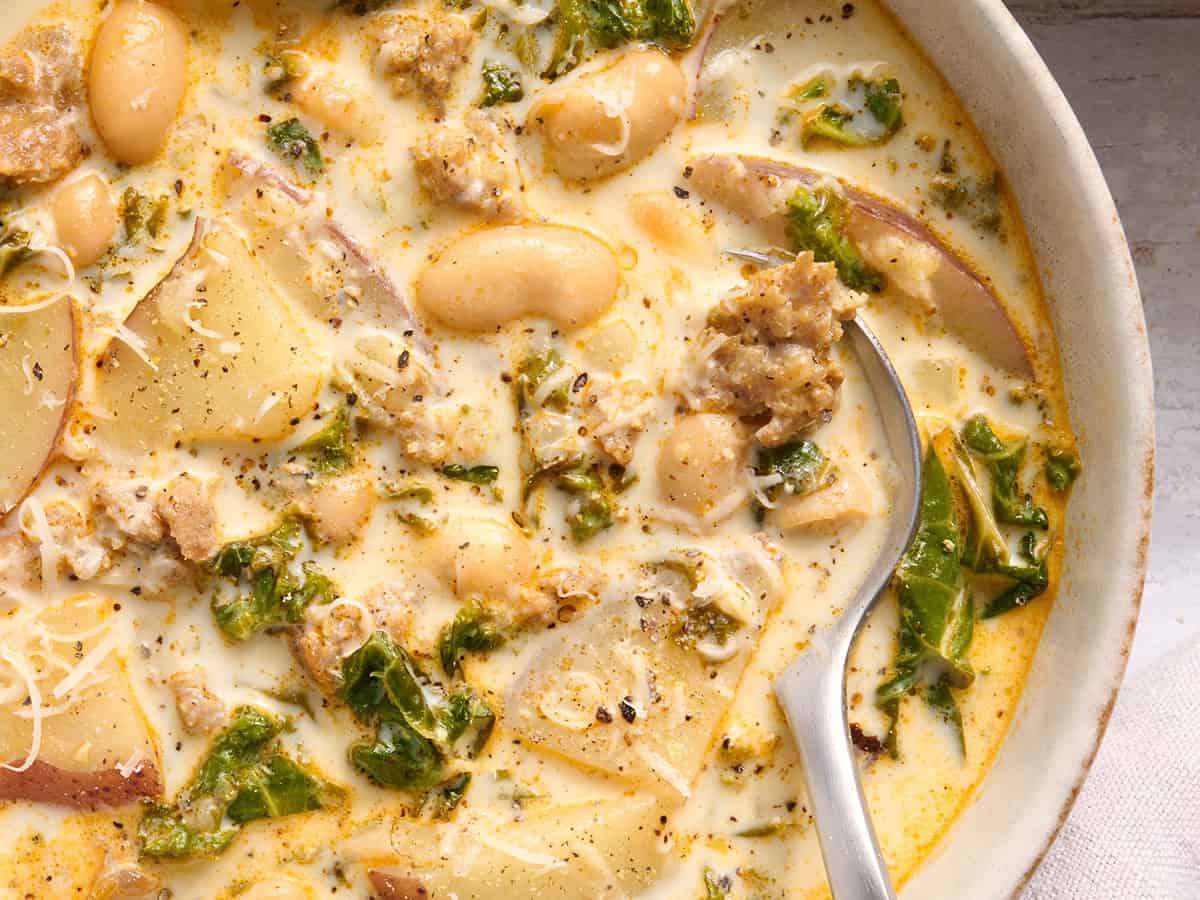 Overhead close up of homemade zuppa toscana in a bowl with a spoon.