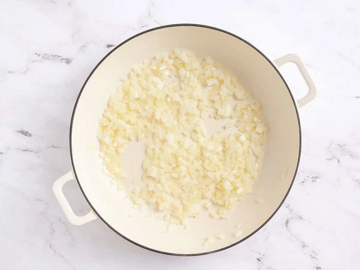Melted butter and diced onions in a skillet.
