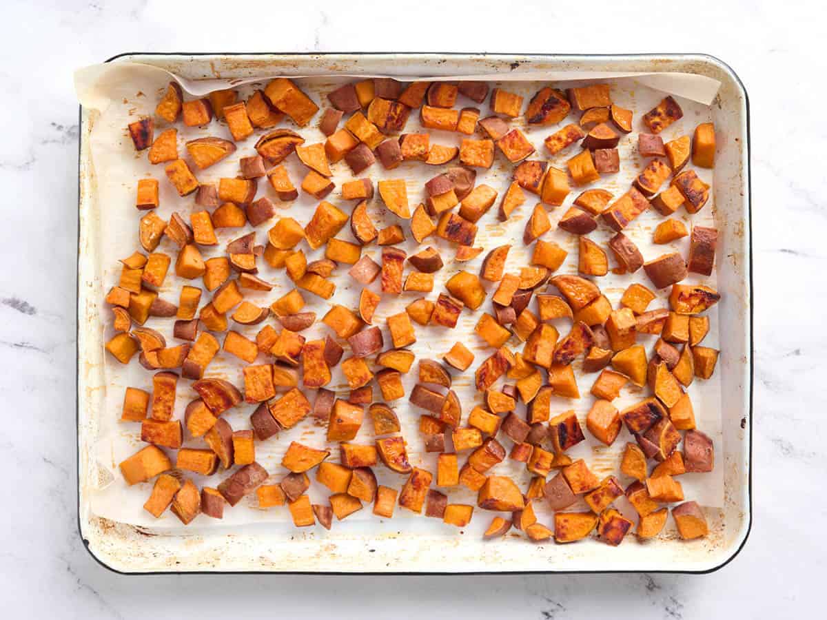 Roasted sweet potatoes on a baking sheet.