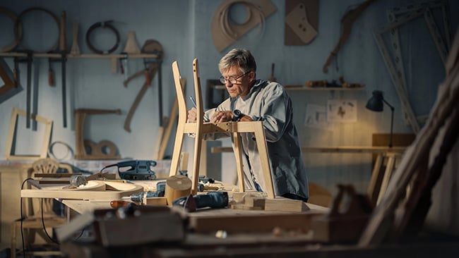 Older man working on a woodworking project in his workshop