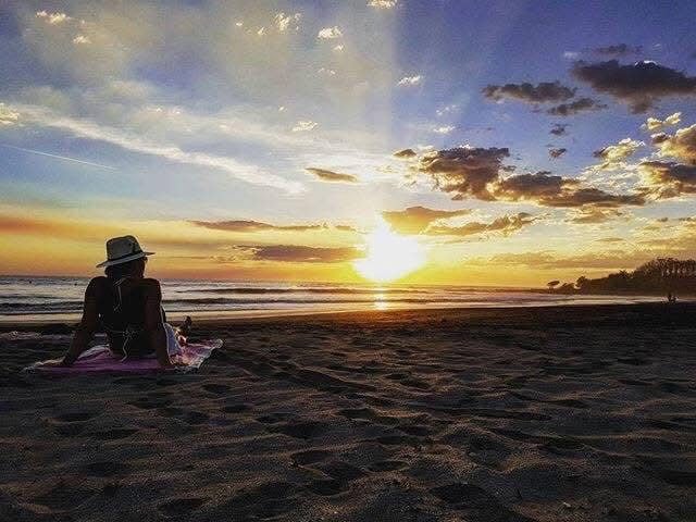 solo woman on a beach in costa rica