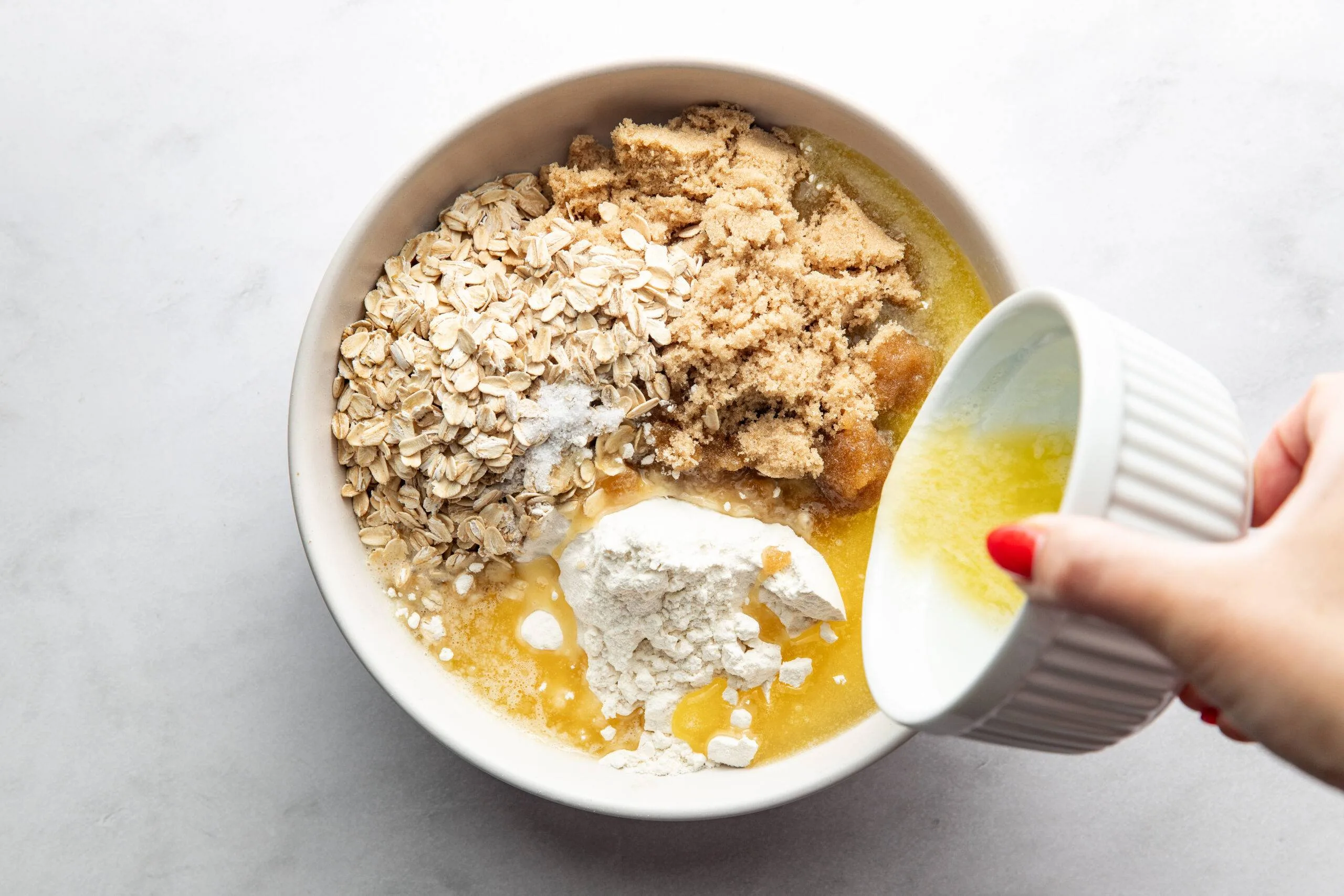 Mixing crumble in a bowl.