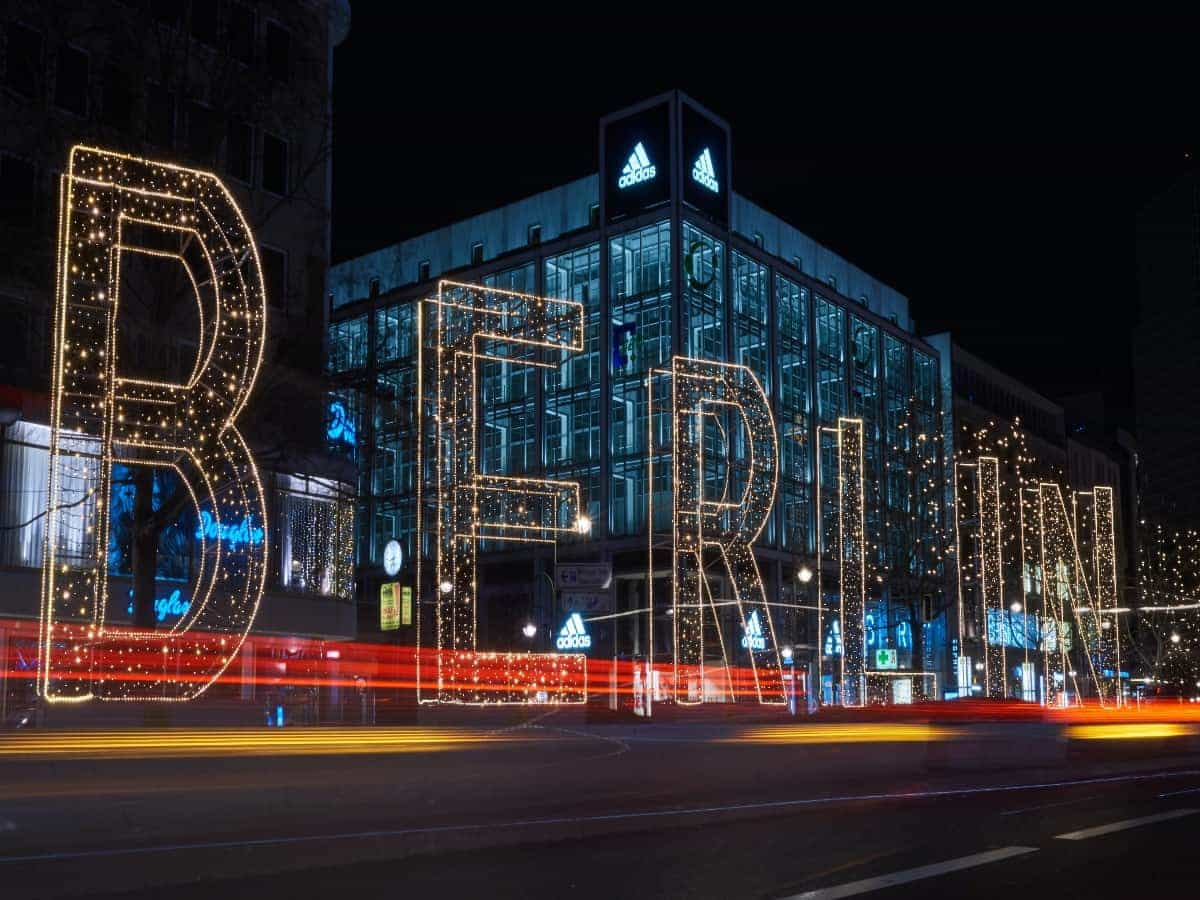large "berlin" light lit up at night in front of city building
