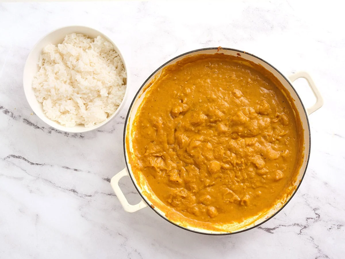 A pot of finished pumpkin curry and cooked rice.