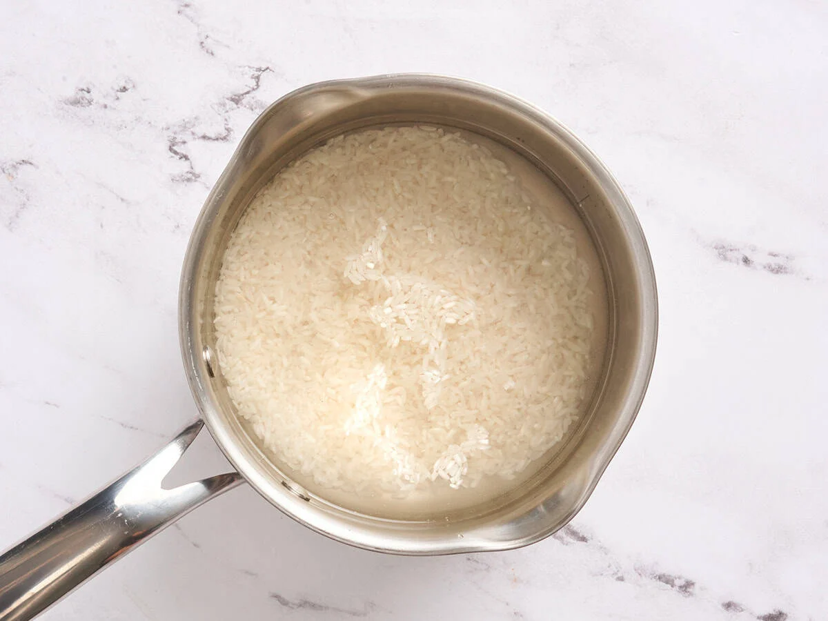 Rice cooking in a sauce pan.