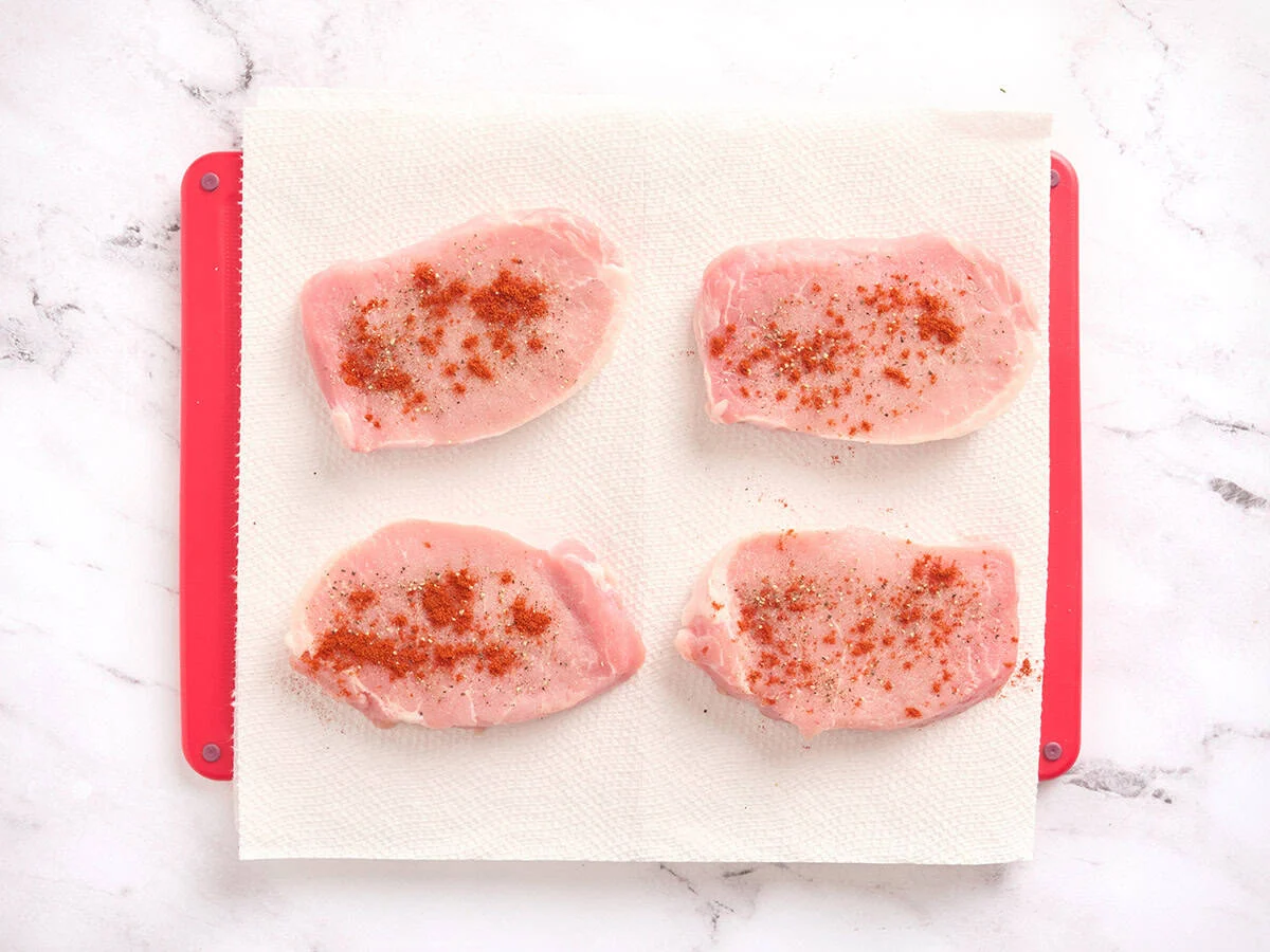 Pork chops seasoned with salt, pepper and paprika.