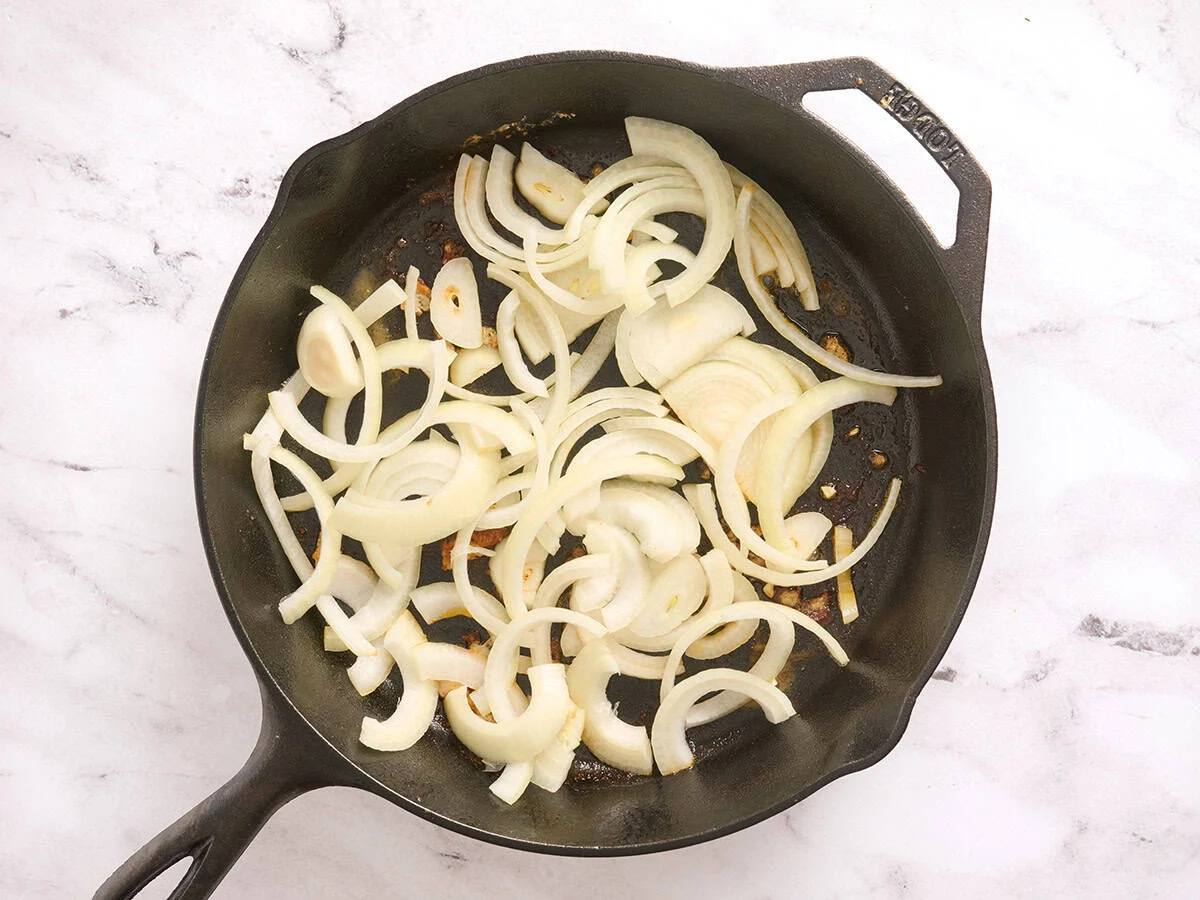 Sliced onions in a skillet.