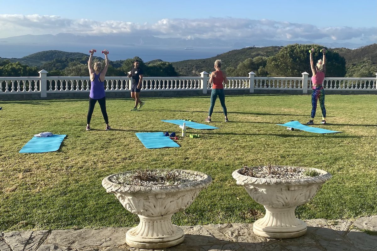 A groupd of women doing yoga on an alcohol-free travel trip with Dry Tripping Travel
