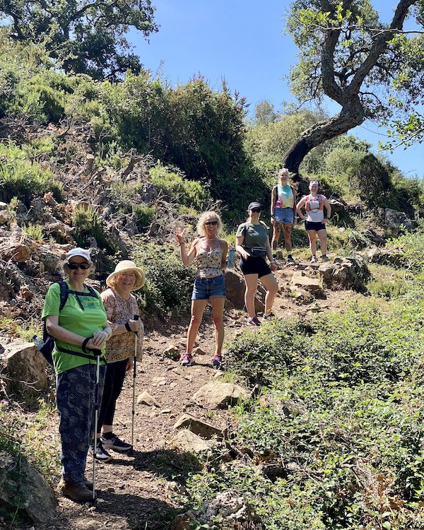 A groupd of women hiking on an alcohol-free travel trip with Dry Tripping Travel