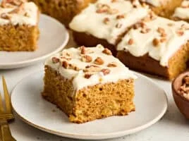 Side view of a slice of carrot cake on a plate