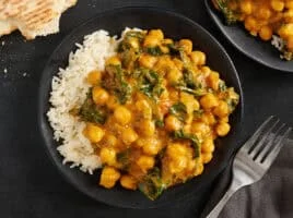 Overhead view of coconut curry chickpeas on a plate with white rice.