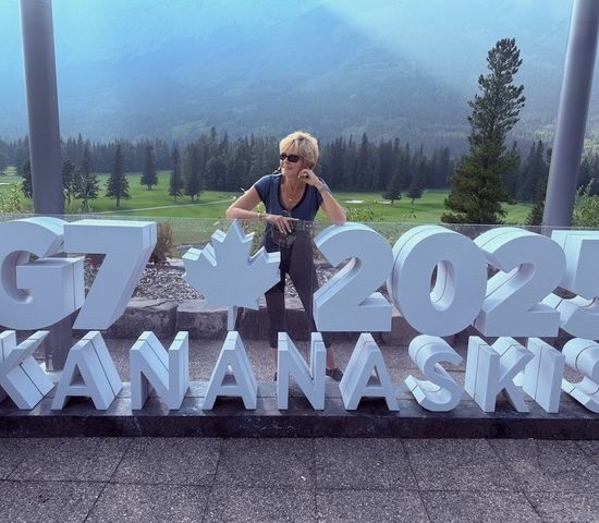 Erin Davis at the G7 sign, 2025