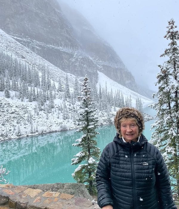 A woman in front of a snowy lake in Banff, Alberta