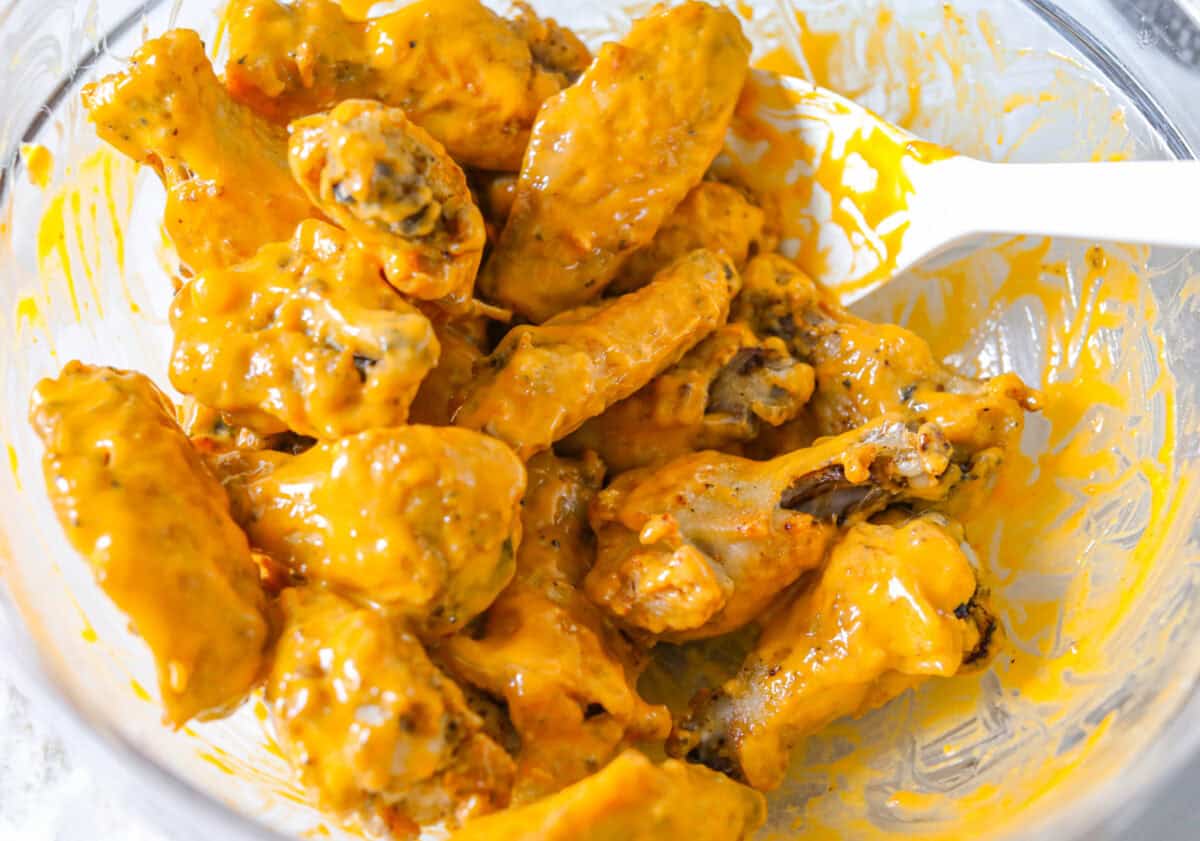 Get ready to get a little messy with these gold fever chicken wings! Baked until crispy and tossed in a sweet, tangy, buttery sauce with a kick of heat, they're perfect for game day, parties, or anytime a wing craving hits! Crispy baked chicken wings coated in the Gold Fever sauce.