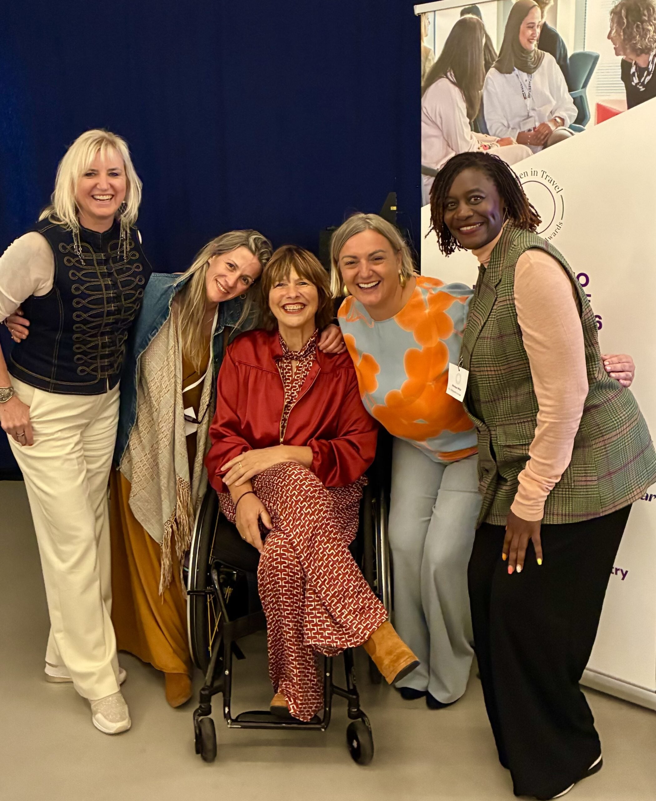 five women smiling at a diversity event