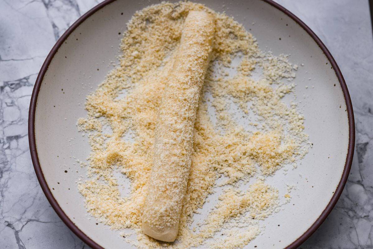 Baked breadstick rolled in parmesan cheese. 