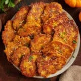 Overhead view of a plate of pumpkin fritters.