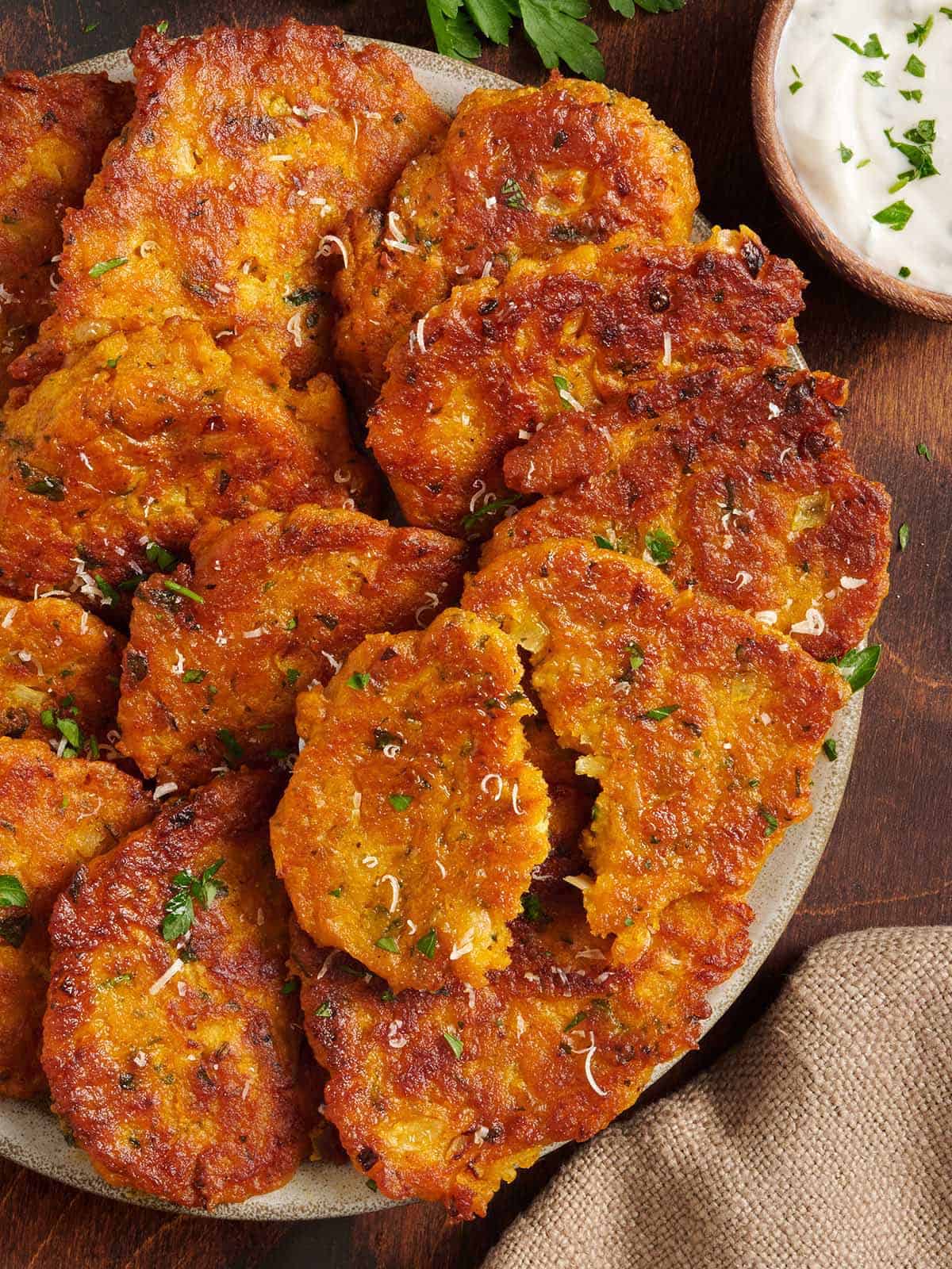 Overhead view of a plate of pumpkin fritters.