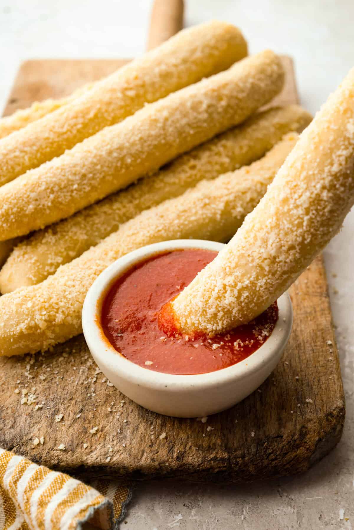 Soft garlic Parmesan Little Caesars crazy bread breadsticks served with marinara dipping sauce.
