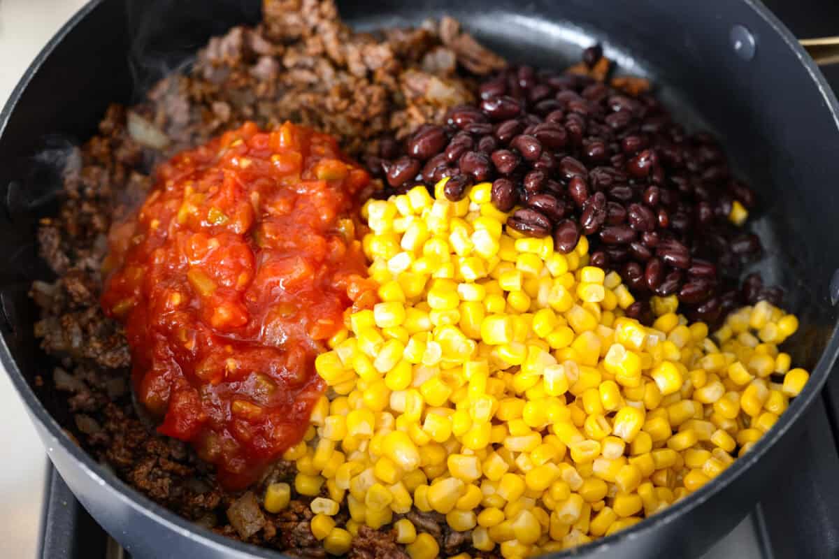 Salsa, corn, and black beans added to the skillet. 